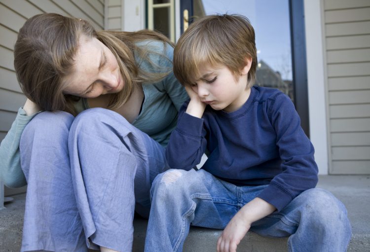 MOTHER AND SON SITTING ON PORCH